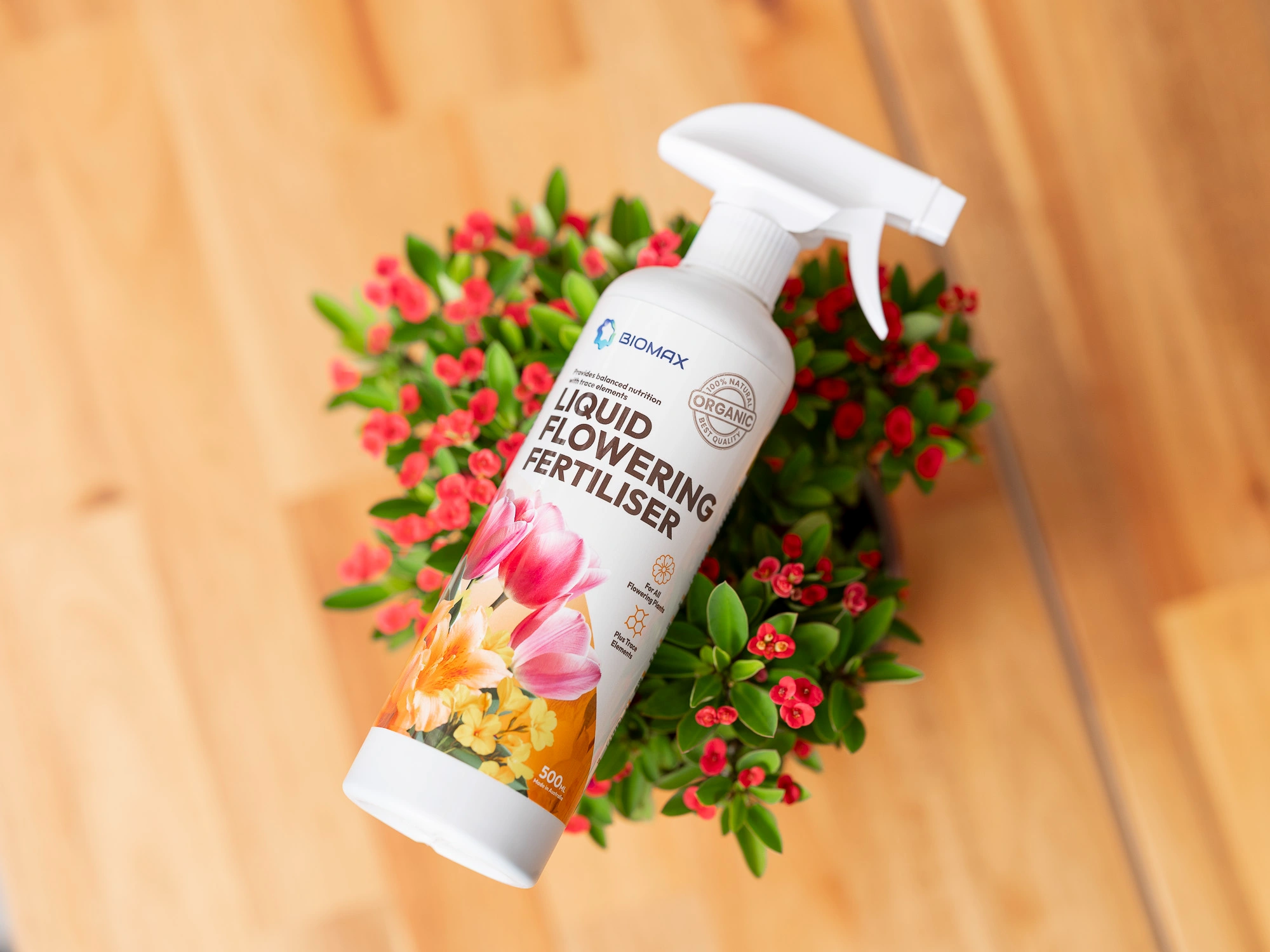 Biomax Liquid Flowering Fertiliser Singapore bottle top view with flowering plant